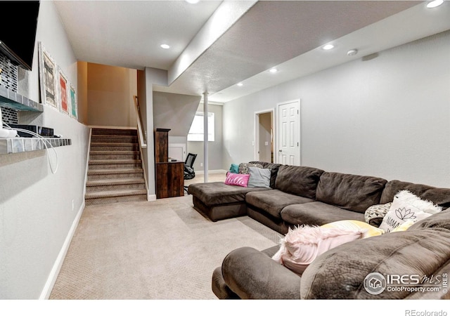 carpeted living area featuring recessed lighting, baseboards, and stairs