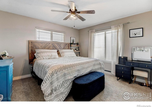 carpeted bedroom with multiple windows, ceiling fan, and baseboards