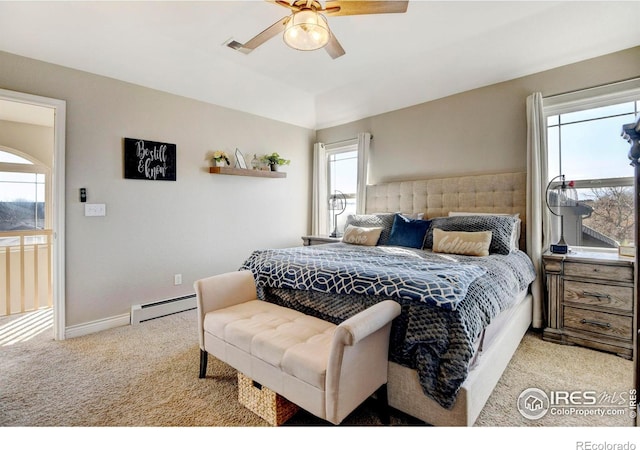 bedroom with a baseboard heating unit, carpet floors, a ceiling fan, visible vents, and baseboards