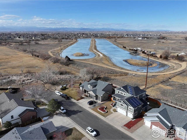 drone / aerial view with a water view and a residential view