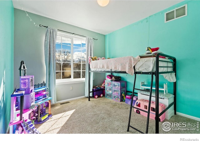 carpeted bedroom featuring baseboards and visible vents