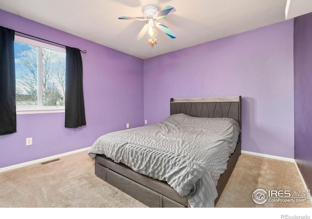 carpeted bedroom featuring visible vents, ceiling fan, and baseboards