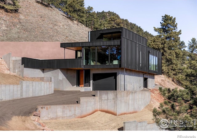 rear view of house with a garage