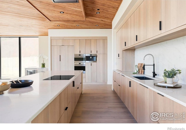 kitchen featuring wooden ceiling, light brown cabinets, a sink, tasteful backsplash, and modern cabinets