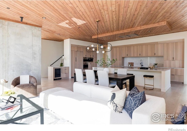 living area with a chandelier, wine cooler, light wood-type flooring, and wood ceiling