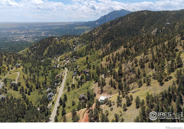 drone / aerial view featuring a mountain view and a wooded view