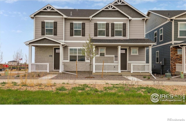 craftsman-style home with covered porch and brick siding