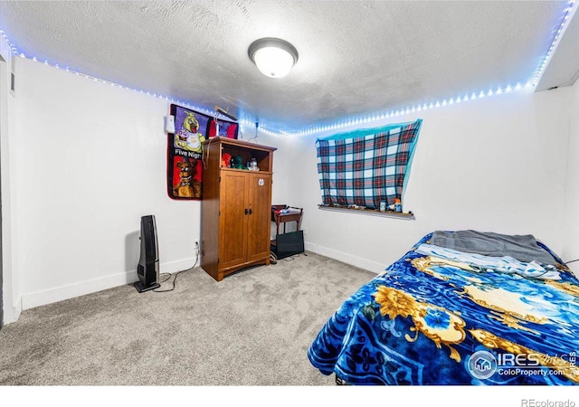 bedroom with baseboards, a textured ceiling, and light colored carpet