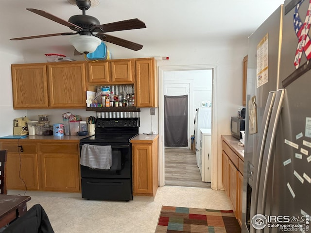 kitchen with brown cabinets, black appliances, a ceiling fan, and light countertops