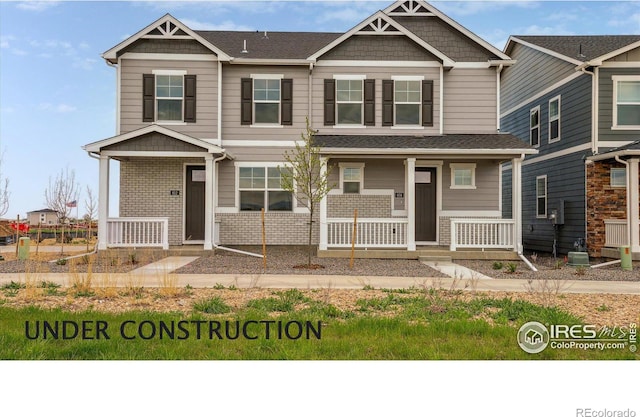 craftsman inspired home with a porch and brick siding