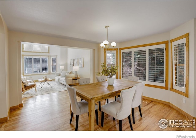 dining room with light wood-style flooring and baseboards