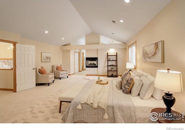 bedroom with light carpet, visible vents, vaulted ceiling, a multi sided fireplace, and recessed lighting