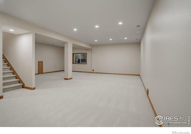 finished below grade area featuring carpet floors, recessed lighting, stairway, and baseboards