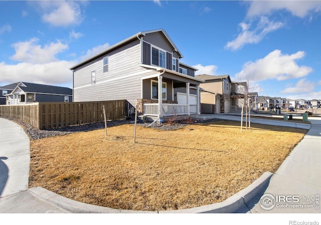 view of property exterior featuring fence and a residential view