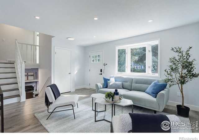 living room with baseboards, stairway, wood finished floors, and recessed lighting