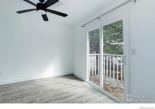 empty room with wood finished floors and baseboards