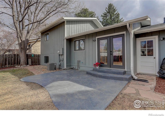 entrance to property featuring central AC, french doors, a patio area, and fence