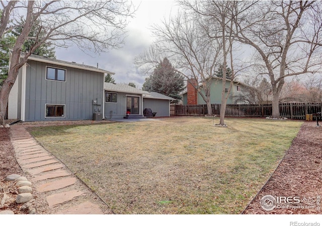 exterior space with entry steps, fence, and a yard