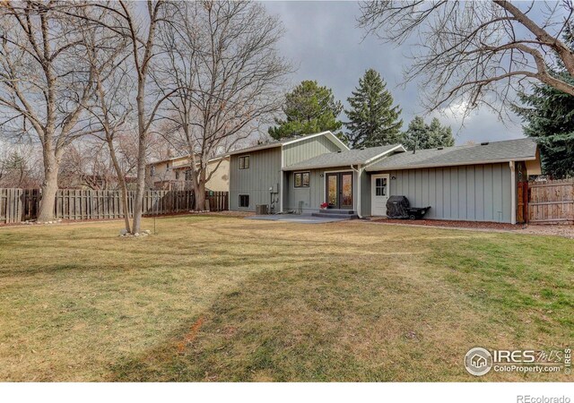 rear view of house featuring a yard, french doors, a patio area, and fence