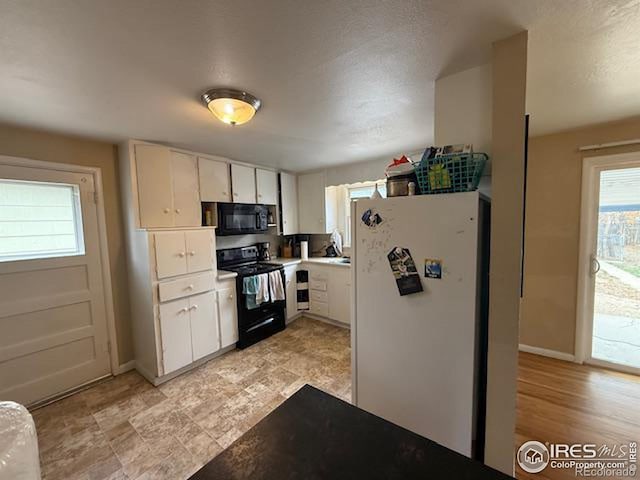606 Sheldon Dr, Fort Collins, CO 80521 - kitchen with black appliances, light countertops, and white cabinets