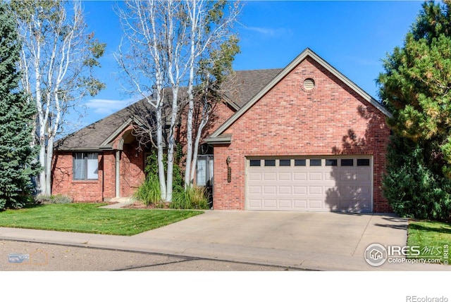 view of front of house with driveway, a front lawn, and brick siding