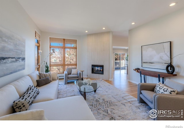 2425 Waneka Lake Trl, Lafayette, CO 80026 - living area featuring wood finished floors, recessed lighting, a tile fireplace, and baseboards