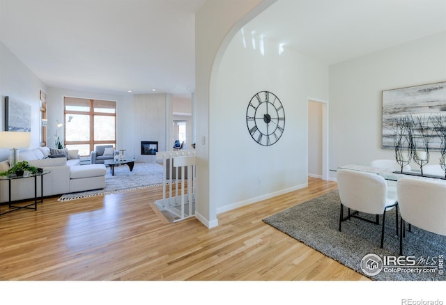 2425 Waneka Lake Trl, Lafayette, CO 80026 - living room with wood finished floors, baseboards, and arched walkways