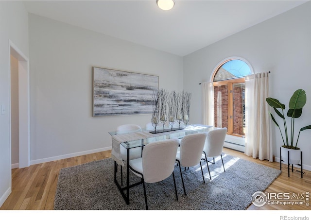 2425 Waneka Lake Trl, Lafayette, CO 80026 - dining room featuring wood finished floors, baseboards, and a baseboard heating unit