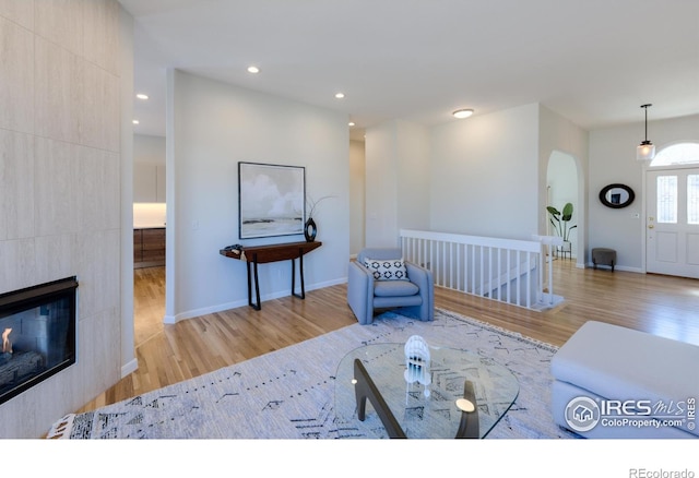 2425 Waneka Lake Trl, Lafayette, CO 80026 - living area with wood finished floors, arched walkways, baseboards, recessed lighting, and a fireplace
