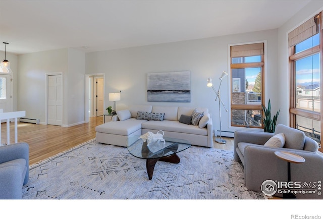 2425 Waneka Lake Trl, Lafayette, CO 80026 - living room with wood finished floors, a baseboard heating unit, and baseboards