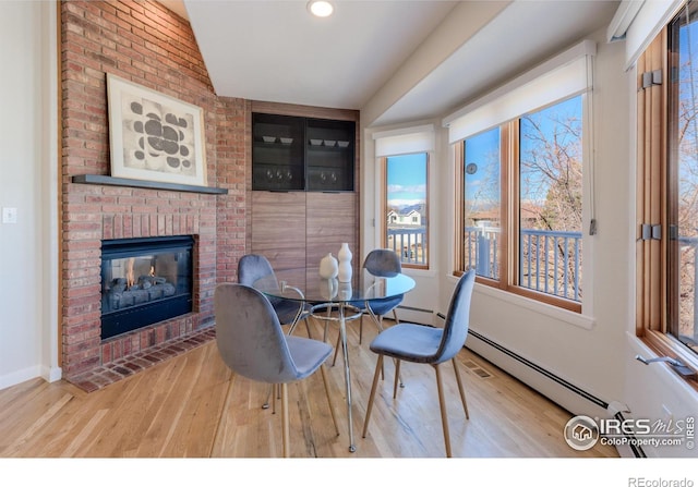 2425 Waneka Lake Trl, Lafayette, CO 80026 - dining room featuring wood finished floors, plenty of natural light, a fireplace, and recessed lighting