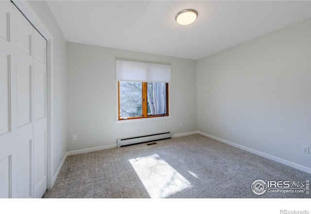 2425 Waneka Lake Trl, Lafayette, CO 80026 - unfurnished bedroom featuring baseboard heating, carpet flooring, baseboards, and a closet