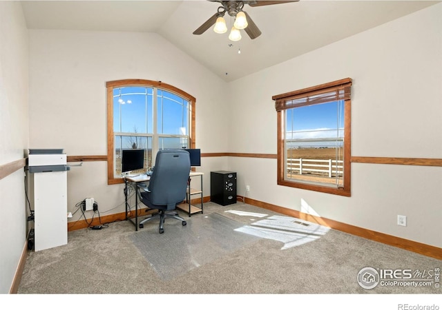 carpeted office space with vaulted ceiling, baseboards, and a healthy amount of sunlight