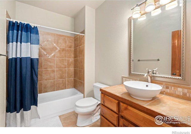 full bathroom with toilet, tile patterned flooring, shower / tub combo with curtain, and vanity