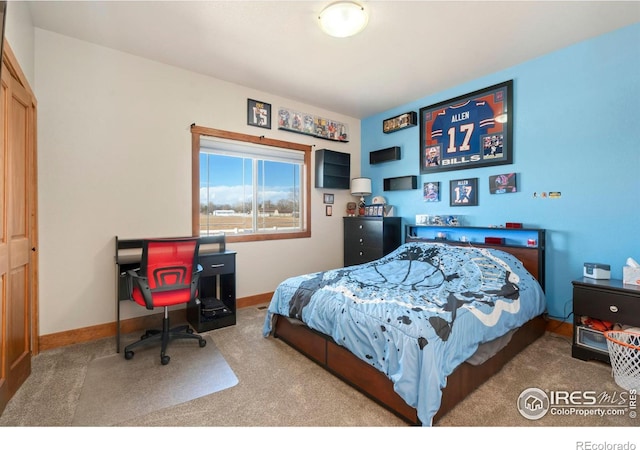 carpeted bedroom featuring baseboards