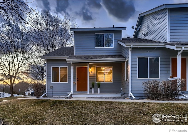 view of front of home with covered porch and a shingled roof