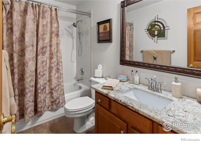 full bathroom with shower / tub combo, vanity, and toilet