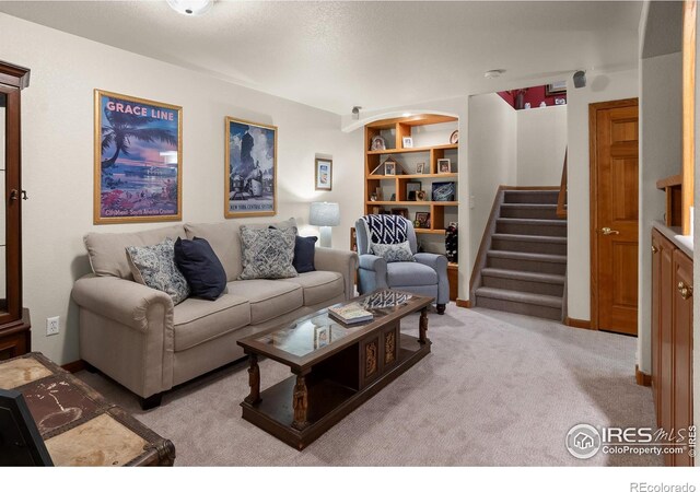 living room featuring stairs and carpet