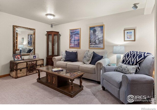 carpeted living room featuring baseboards