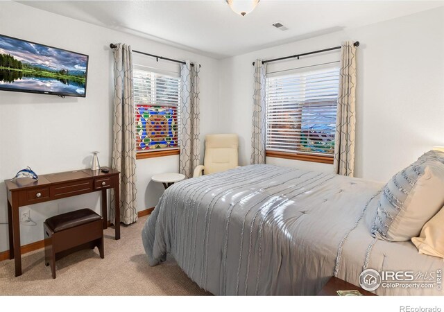 carpeted bedroom with visible vents and baseboards