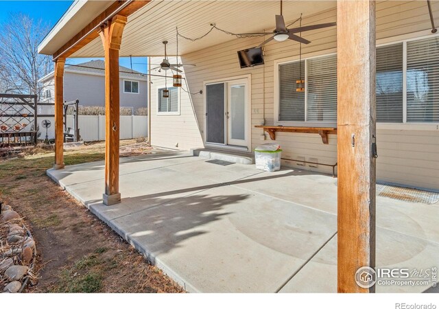 view of patio featuring a ceiling fan and fence