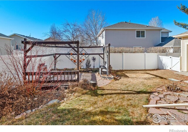 view of yard featuring a fenced backyard and a gate