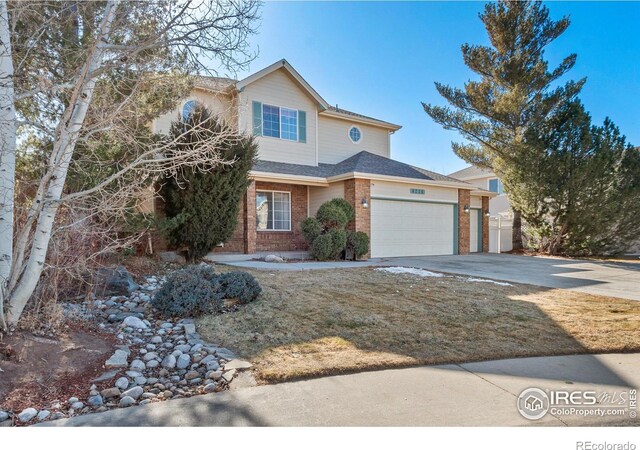 view of front of home with driveway, an attached garage, and brick siding