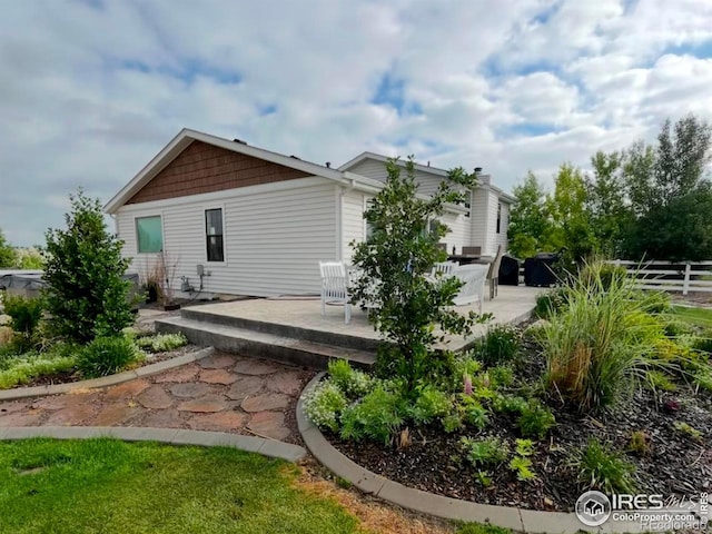 back of property featuring a patio area and fence