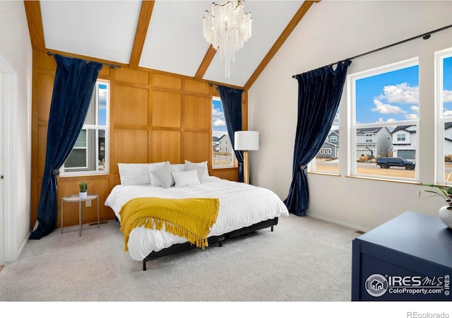 bedroom with vaulted ceiling, multiple windows, carpet flooring, and a notable chandelier