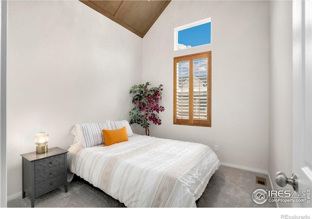 bedroom with vaulted ceiling, carpet floors, visible vents, and baseboards