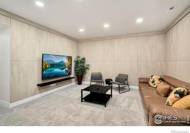 carpeted living room with recessed lighting and visible vents