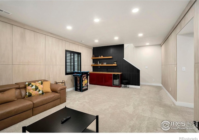 living area featuring recessed lighting, carpet flooring, visible vents, baseboards, and a dry bar