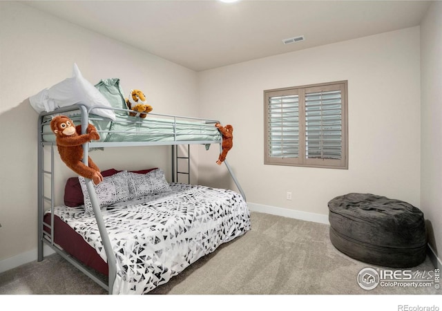 carpeted bedroom featuring visible vents and baseboards