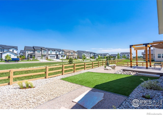 view of yard with a residential view and fence